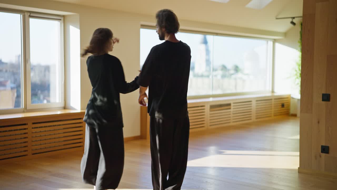 Couple practicing contemporary dance in a bright room