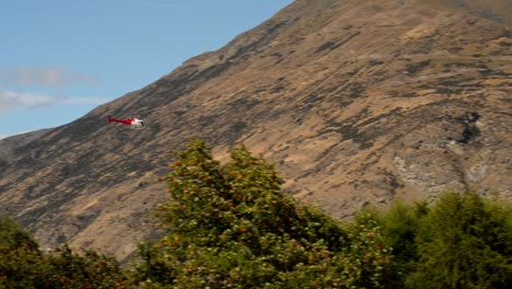 Helicopter-approaching-alpine-airport;-tight-tracking-shot