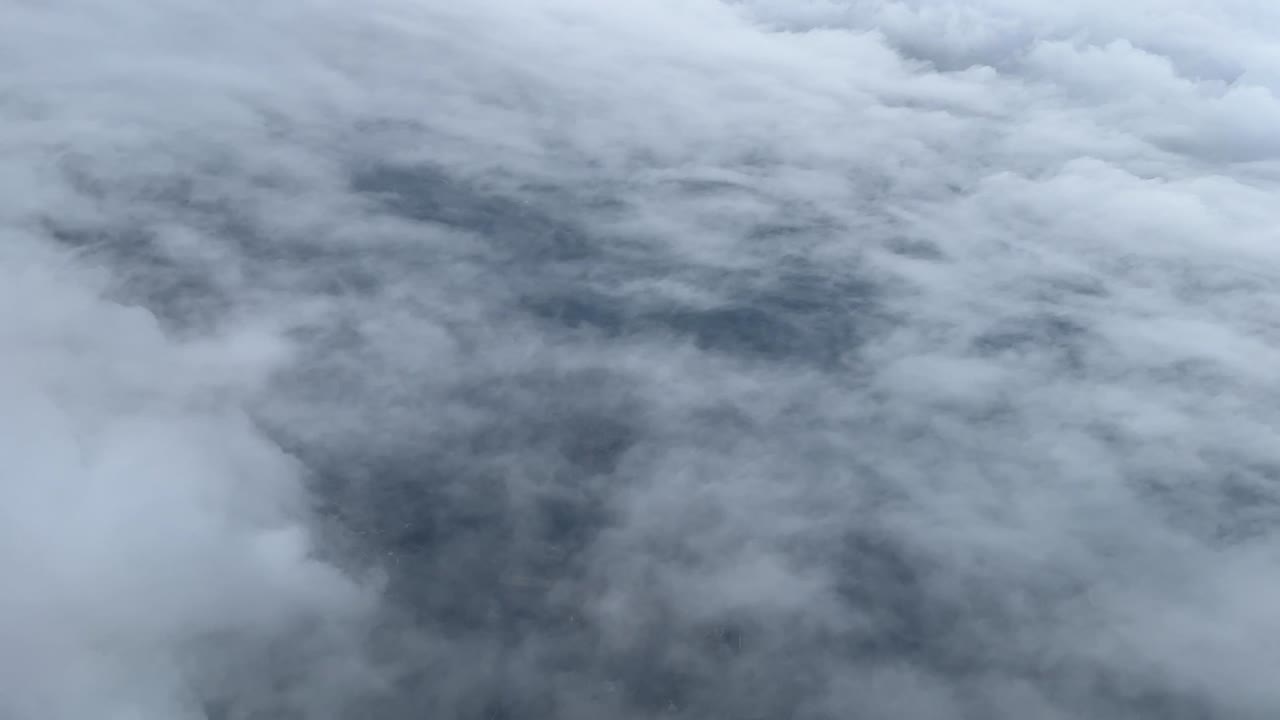 Aerial view from a jet cockpit during the descent for the approach in a cloudy day