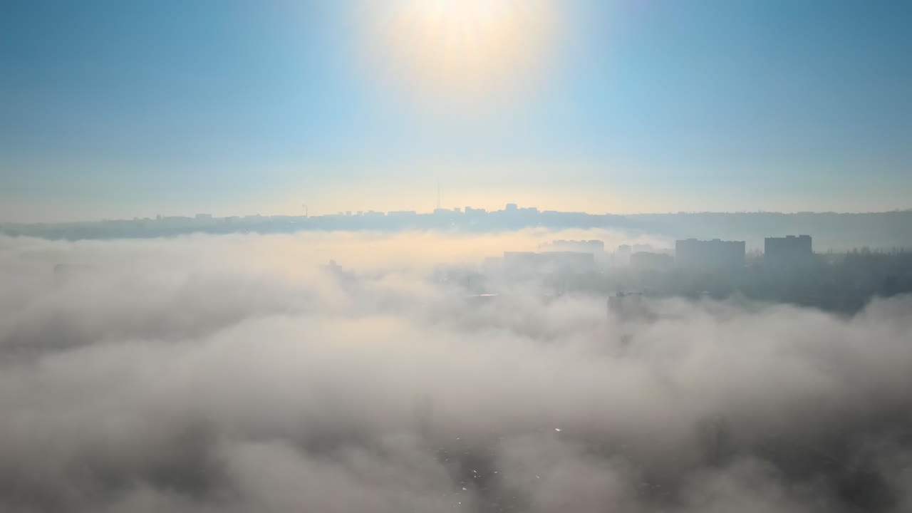Aerial drone view above the clouds with buildings visible through, Chisinau, Moldova