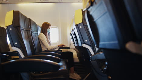 mujer trabajando en una computadora portátil en un avión