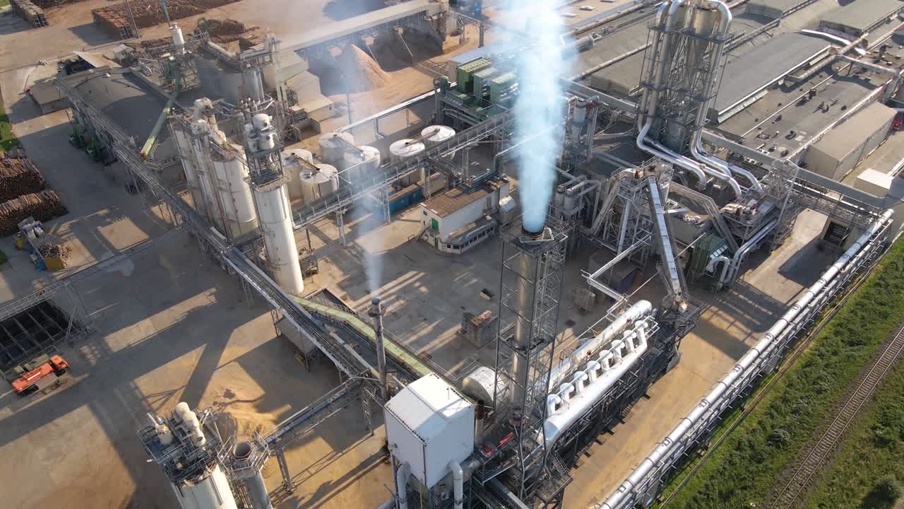 Aerial view of wood processing factory with stacks of lumber at plant manufacturing yard