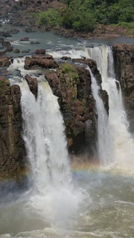 brazil iguazu falls waterfall scenery, iguacu falls landscape vertical video for social media instagram reels and tiktok, beautiful big massive powerful waterfalls in brazil in dramatic tropical scene