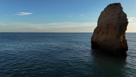 sea stack. algarve portugal, panning drone shot.