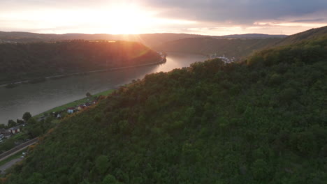 Flying-over-the-hills-of-Braubach,-Germany-with-the-sunsetting-over-the-Rhine-river