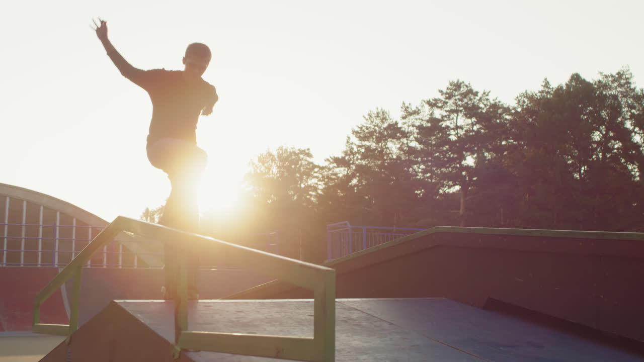 Teenager Skating Rail in Skatepark