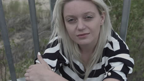 an ill woman sitting alone outside in a wind weather