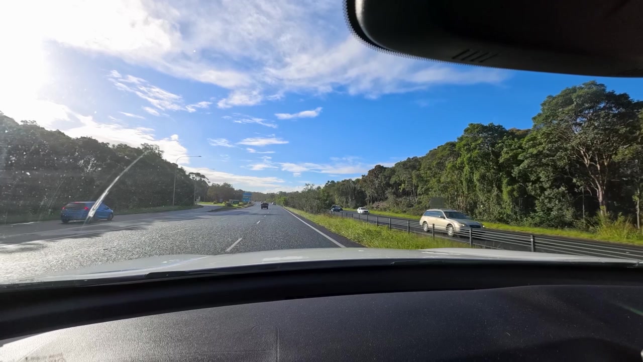 Point of view camera footage driving along a multi-lane sunny highway in Chinderah, Australia.