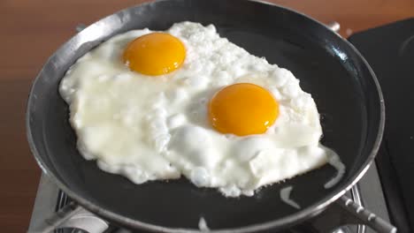 fried eggs in hot pan