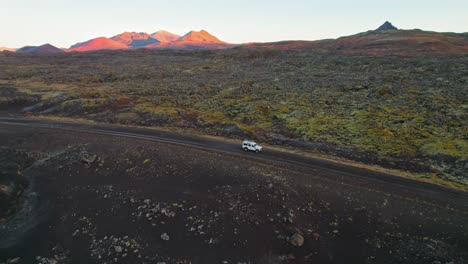 land rover suv blanco conduciendo a través del terreno del paisaje volcánico de islandia