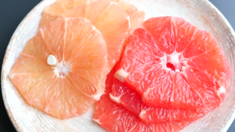 fresh grapefruits on plate on table