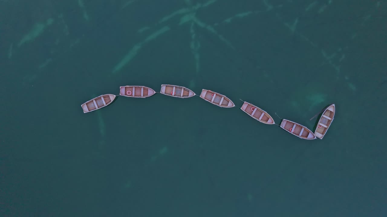 Wooden rowing boats on alpine lake in the Dolomites, South Tyrol, Italy