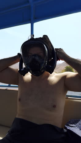 man preparing for snorkeling in a boat