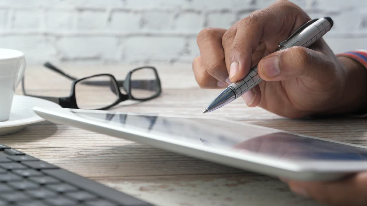 persona que utiliza el comprimido y la pluma