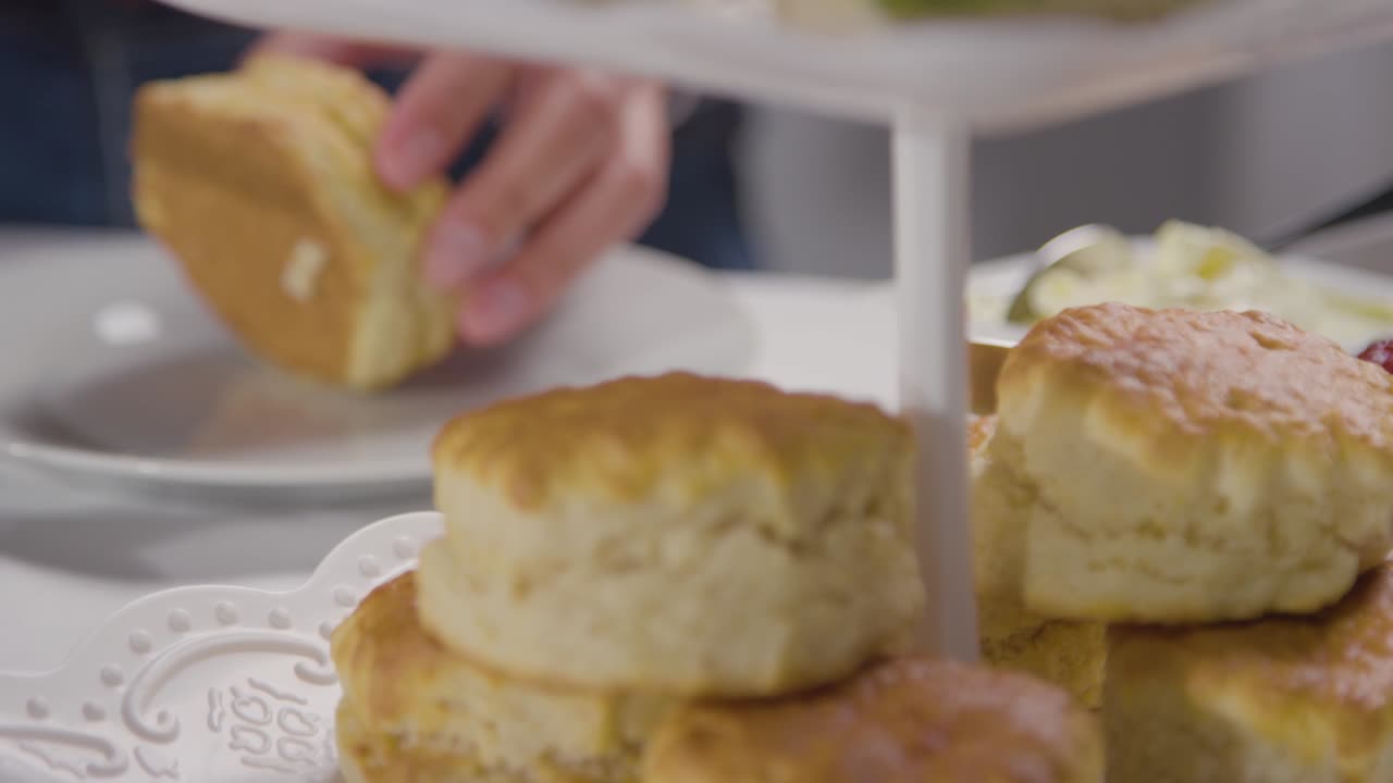 Close Up Shot Of Person With Traditional British Afternoon Tea With Scones Cream And Jam 1