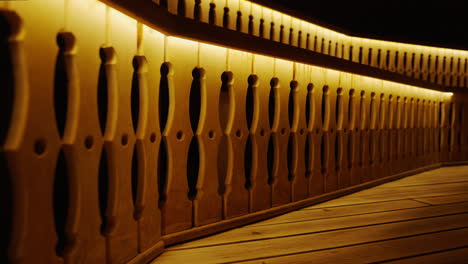 illuminated wooden railing at night