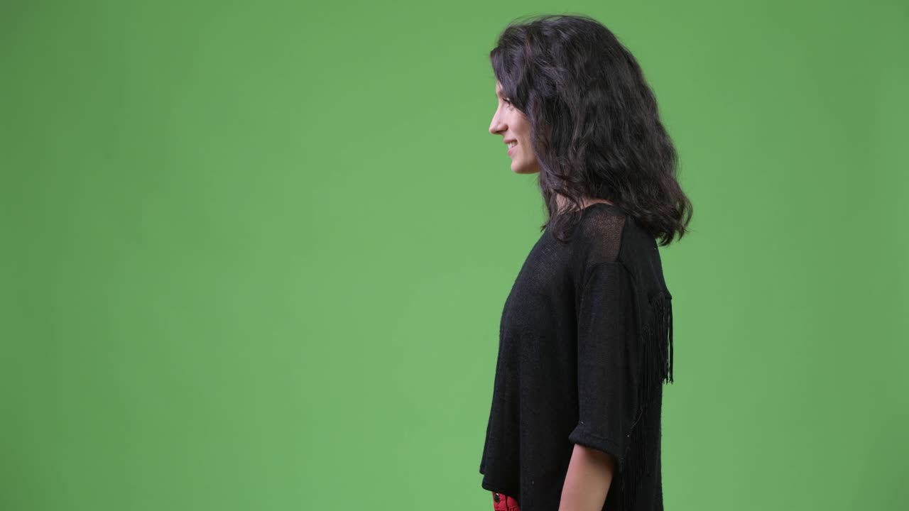 Profile view of happy young beautiful woman smiling