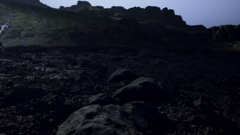 lunar like landscape at twilight with rocky terrain and distant hills