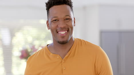 Portrait-of-happy-african-american-man-with-short-hair-at-home,-slow-motion