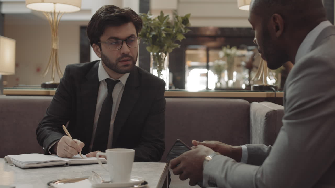 Managers Having Meeting in Cafe