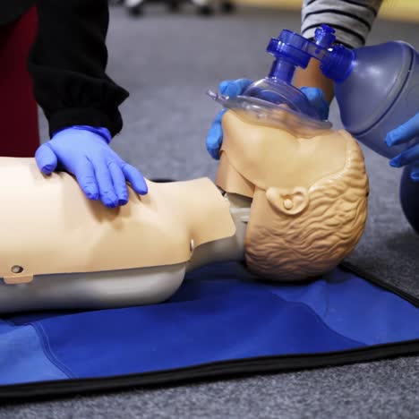 training compression on a dummy. cpr exercise on a mannequin in the medical center. teaching skills during heart attack