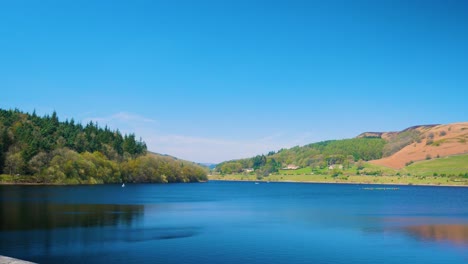 lady bower reservoir beautiful scenery forest in the background on the left and mountains on the right peak district clear skies sunny day shot in 4k