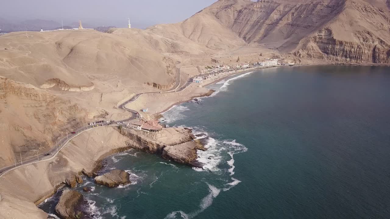 Expansive aerial view of a rugged coastline with towering cliffs, winding roads, and crashing ocean waves. Ideal for travel content, wall art, and editorial use. Leap of the Friar.