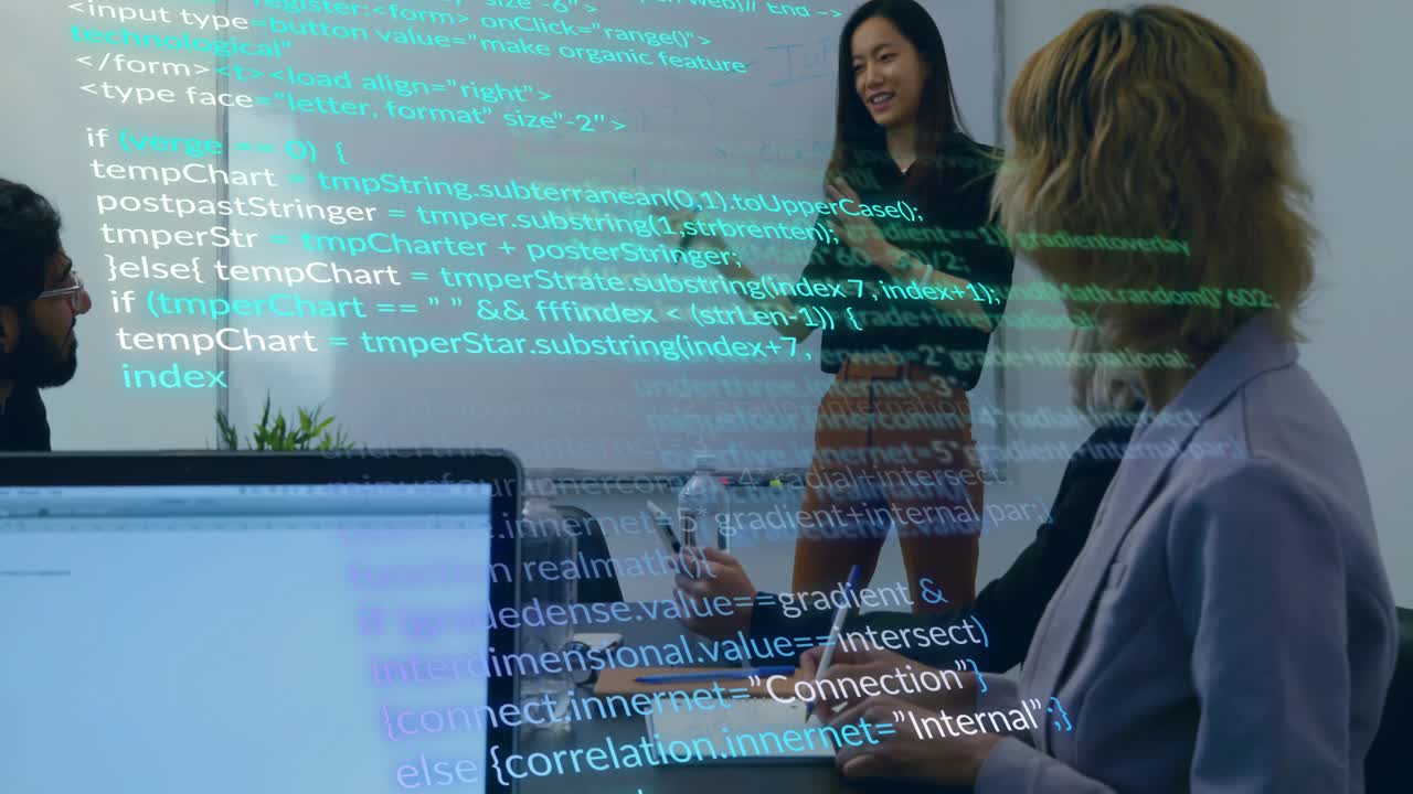 Presenter pointing at code overlay in tech meeting while explaining variables and colleagues noting