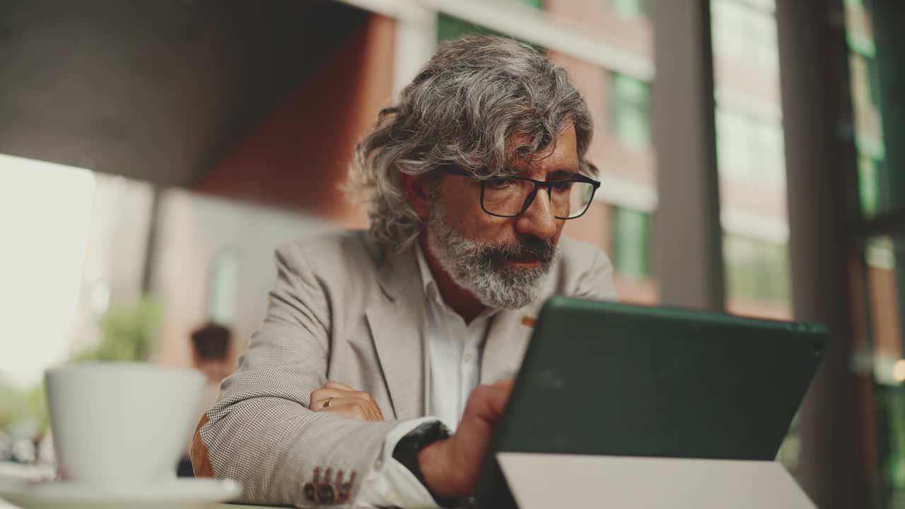 Man using tablet at a coffee shop
