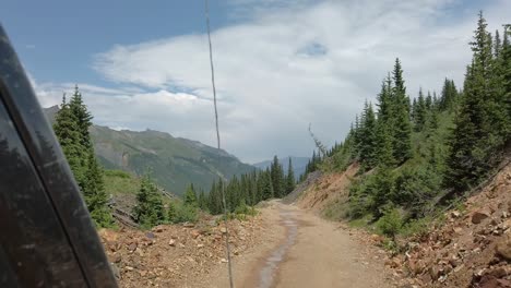 pov while driving a off road vehicle on a narrow portion of alpine loop trail through the san juan mountains near silverton colorado