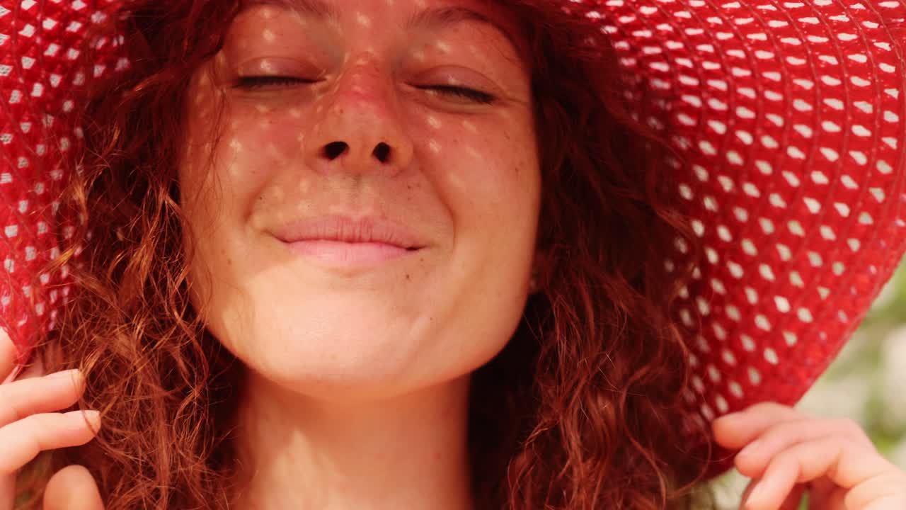 Woman wearing a red straw hat