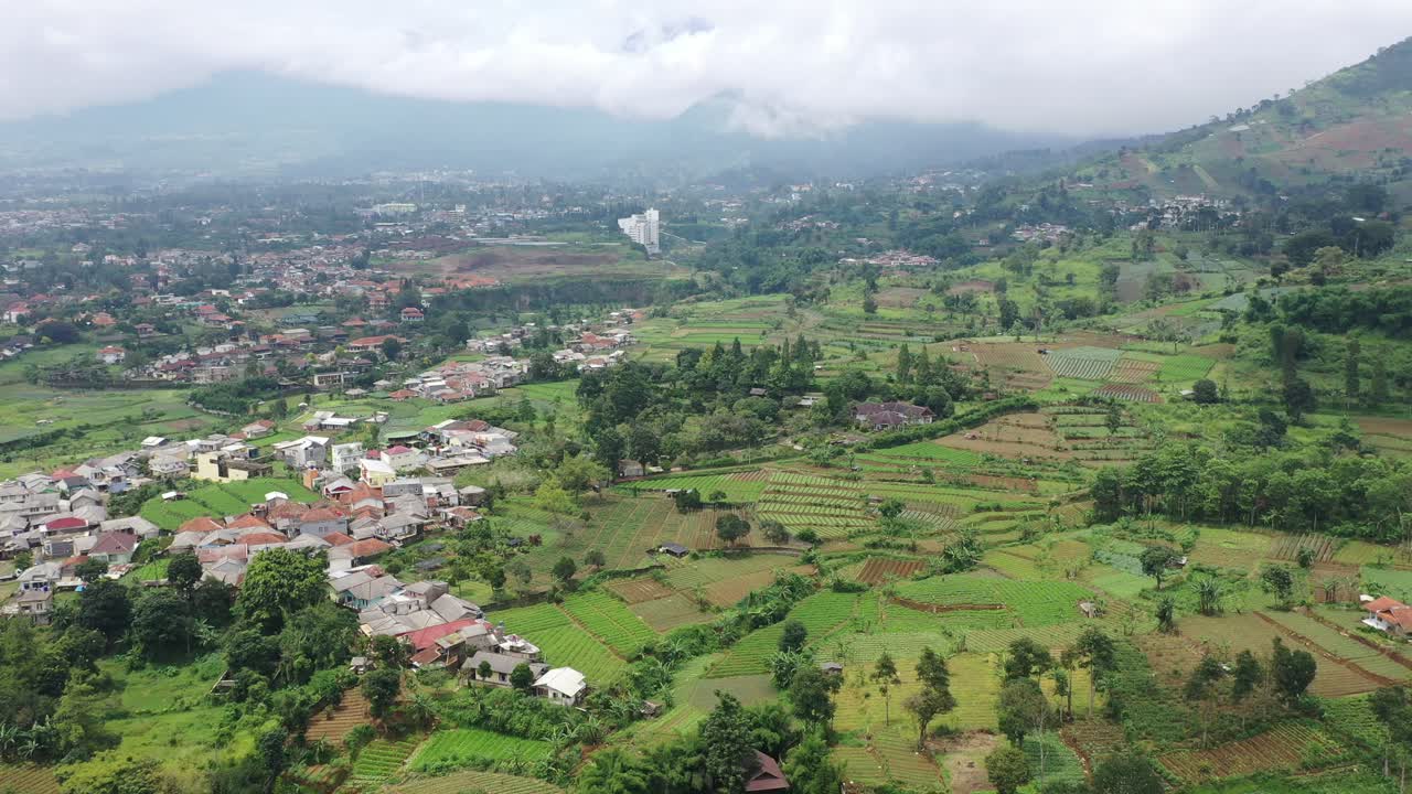 Aerial View of a Mountainous Village with Terraced Fields