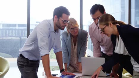 businesspeople interacting over a document