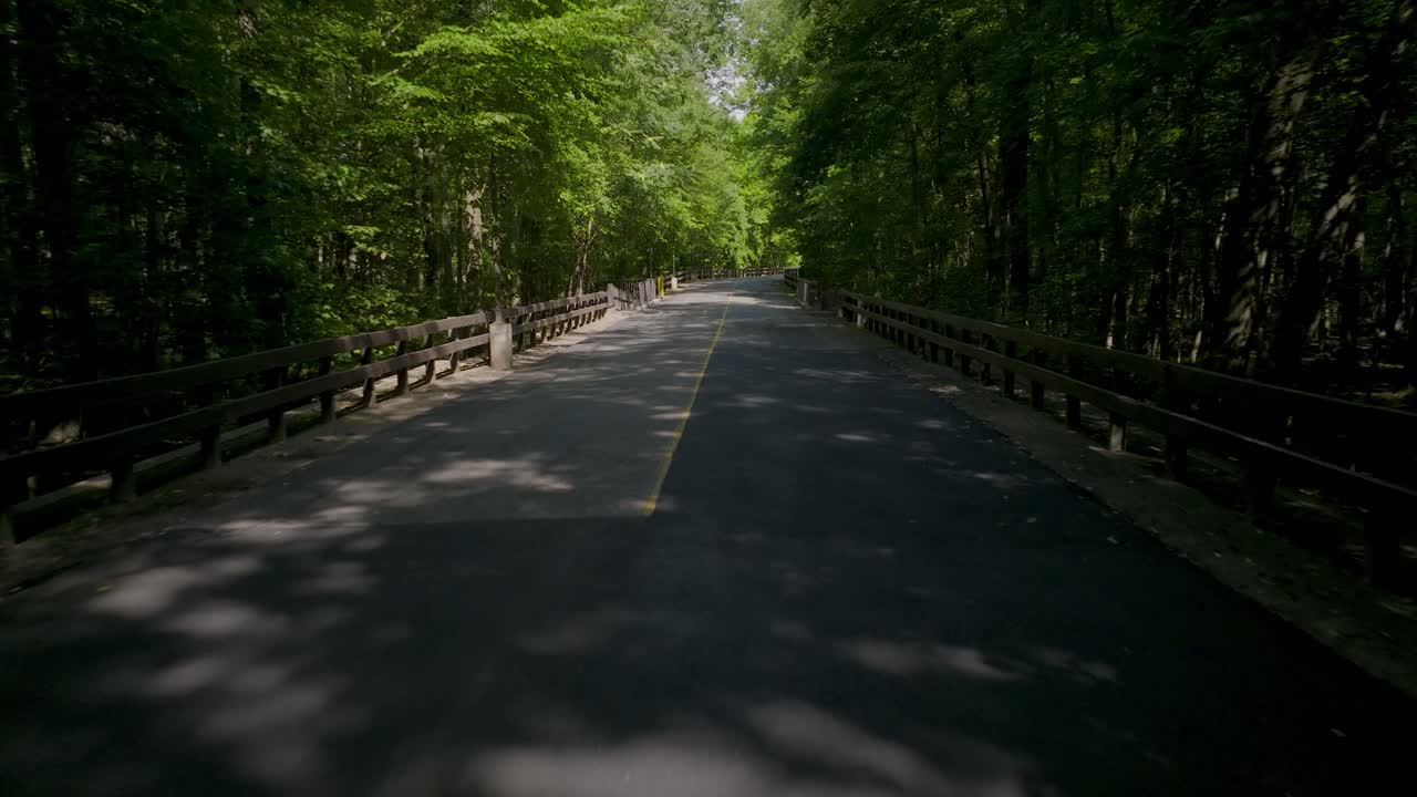 Drone footage flying along a quiet, empty country road