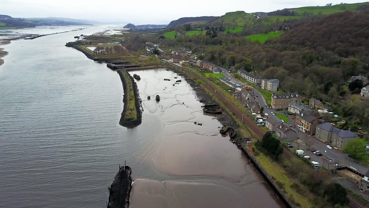 Vecchio relitto di barca arenato e coperto di fango, visibile a causa del basso livello dell'acqua del fiume Clyde nel porto di Bowling, West Dumbartonshire, Scozia.