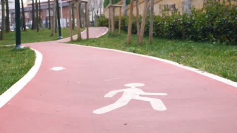 a red walking path in a park