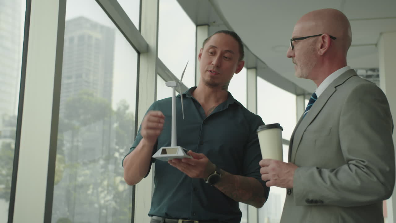 Ecologist Presenting Mockup of Wind Turbine to Male Investor