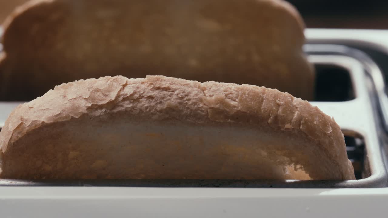Close-Up of Two Browned Bread Slices Popping Out of Toaster