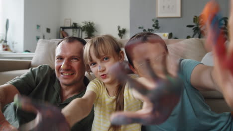 family with paint on hands