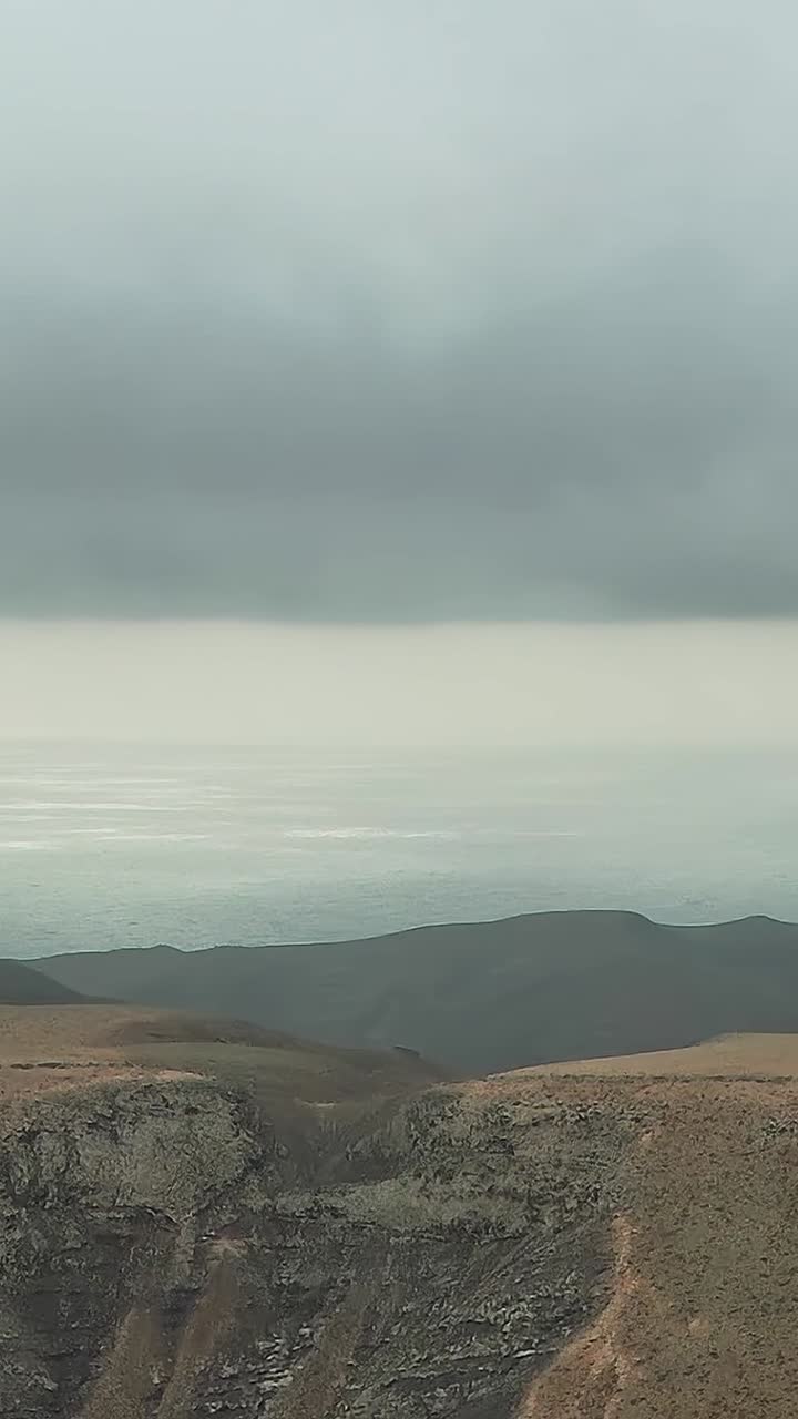 Mountain Range Peaks Emerging Through Clouds