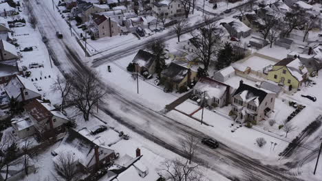 an aerial view over a suburban neighborhood in the morning, after a snow storm
