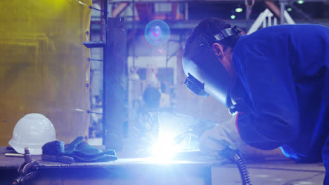 male engineer using welding torch 4k