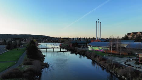 Drone-shot-through-the-Old-Mill-District-of-Bend,-Oregon-during-sunrise