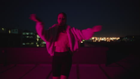 happy-woman-dancing-on-roof-top-girl-performing-hip-hop-dance-style-having-fun-freestyle-dancer-in-urban-city-at-night-with-red-light