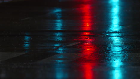 people and car traffic on the road in rainy evening