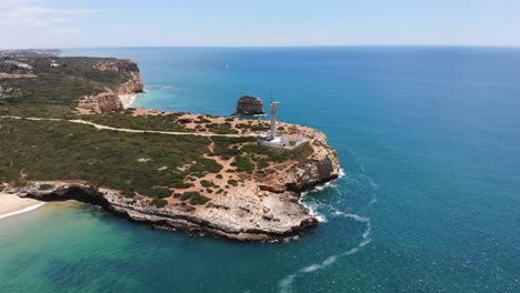 Aerial-shot-towards-Ponta-do-Altar-lighthouse-epic-cliff-coastline,-Ferragudo