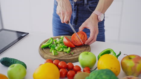high angle close up of female hands chopping bread slices into precise small pieces on wooden board over white table under soft window light, crumbs scattered, focus on calm culinary preparation