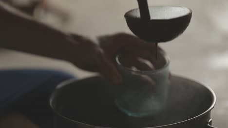 Cacao-ceremony,-liquid-chocolate-being-poured-into-a-cup