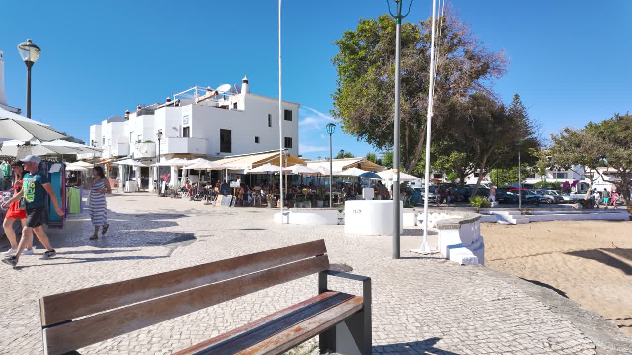 Lively Coastal Town Square with Market Stalls and Outdoor Cafes