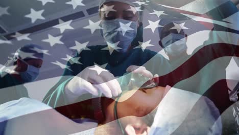 animation of flag of usa waving over surgeons in operating theatre